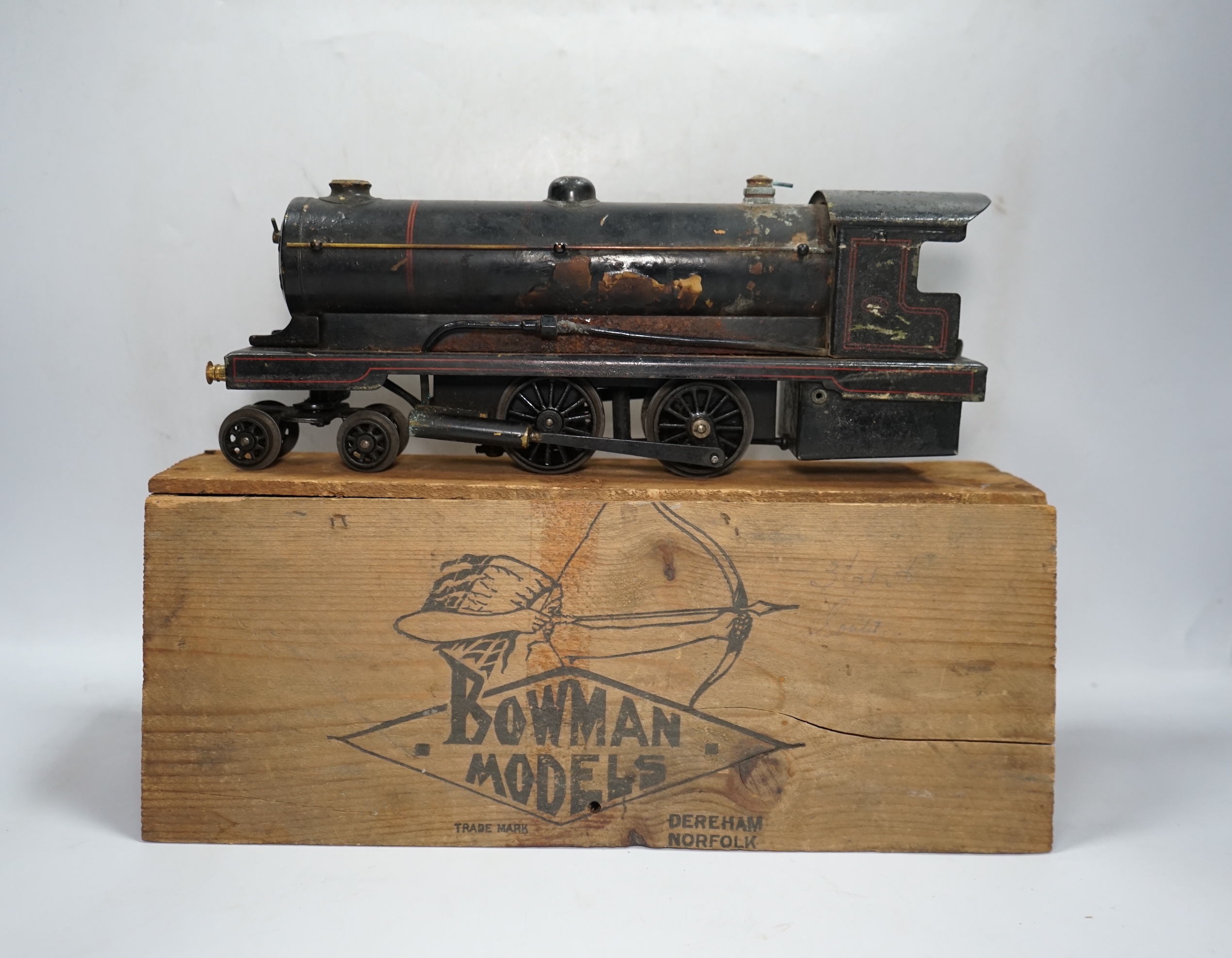 A wooden boxed Bowman Models live steam spirit fired 0 gauge 4-4-0 tender locomotive (without tender), loosely styled in black LNWR livery, together with a tinplate 0 gauge Bing for Bassett Lowke LNER teak bogie coach, 1